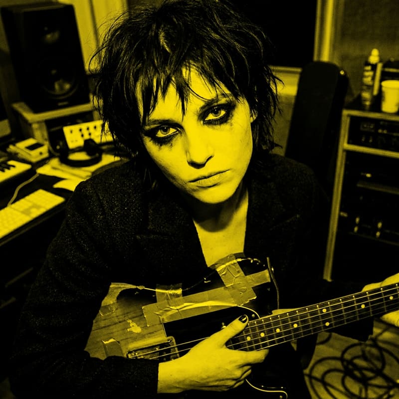High-contrast duotone portrait of noise-pop guitarist Mira Okonkwo in saturated yellow.